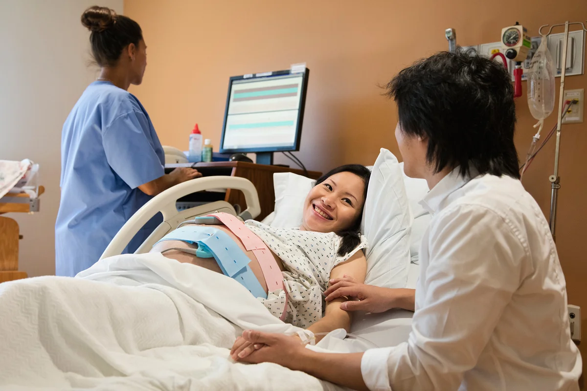 Pregnant woman in hospital bed