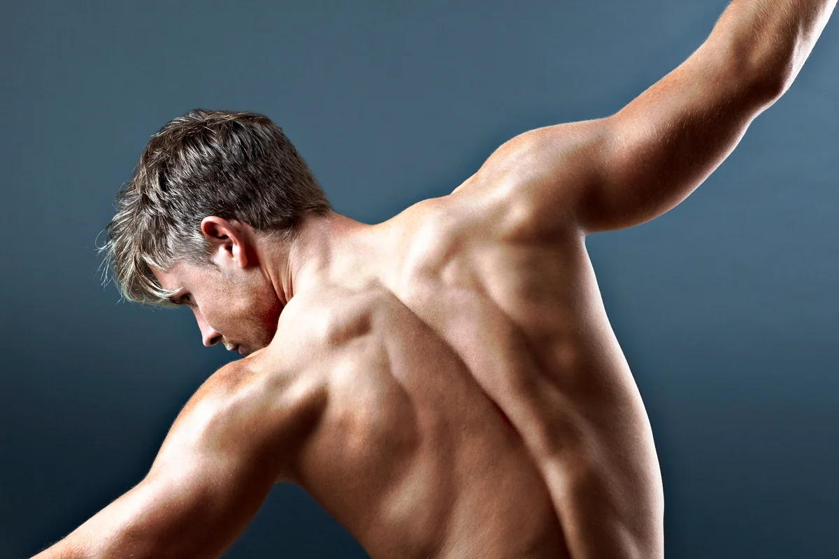 Bare chested man with arms outstretched