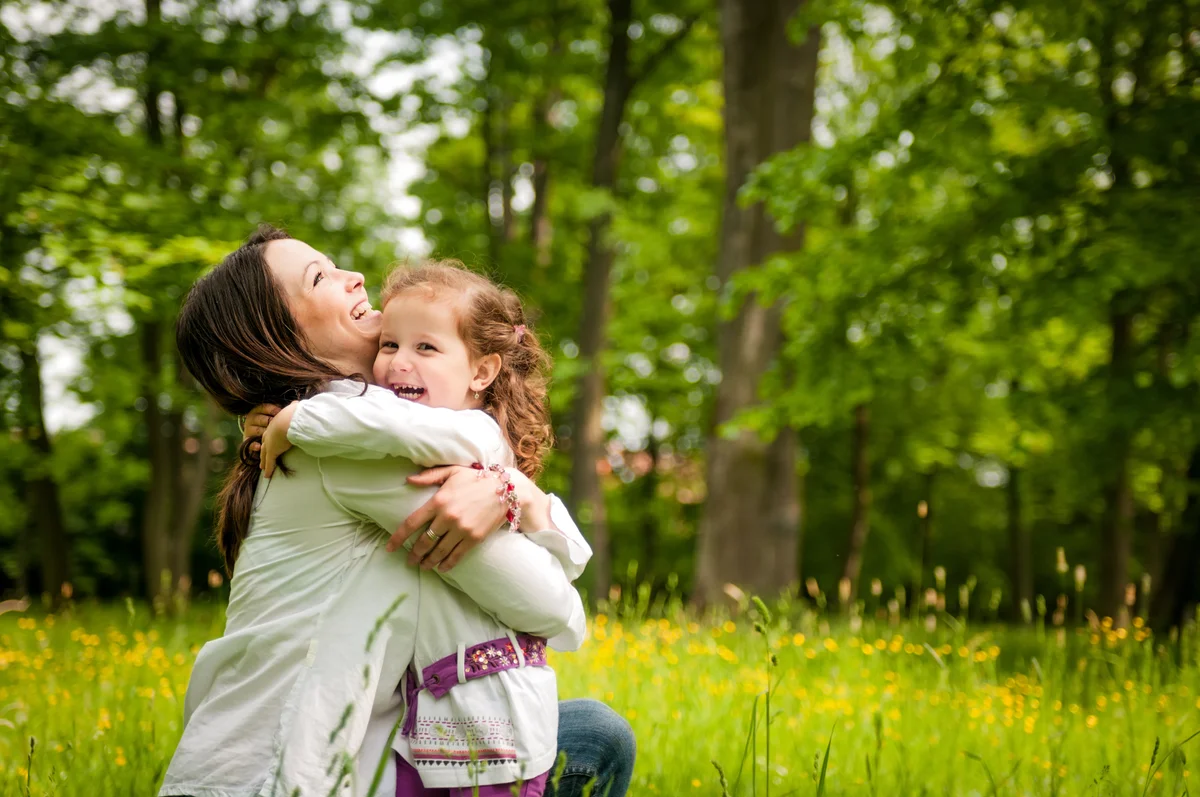 mom hugging daughter