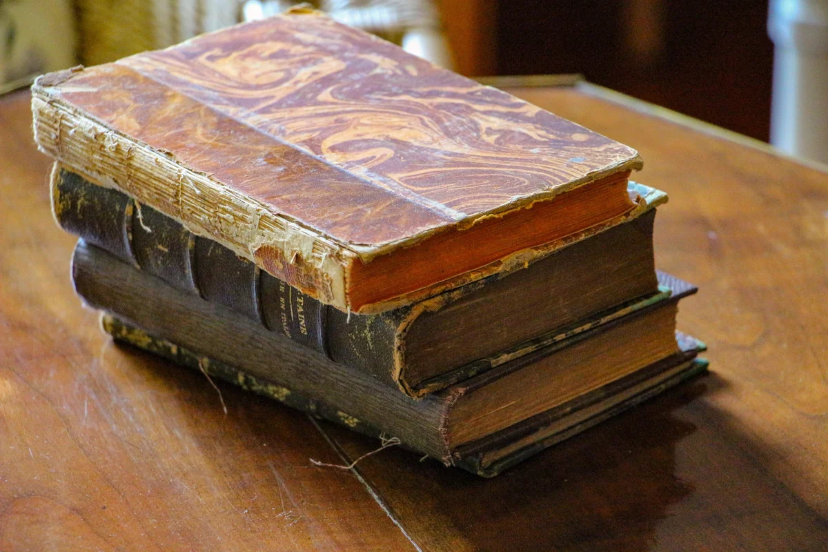 old books stacked on table