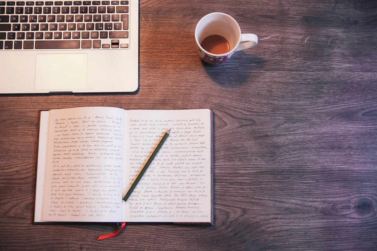 Vintage toned image of a open diary on a wooden desk