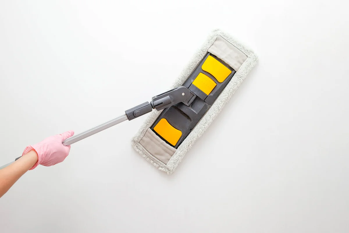 Mop on a white wall concept