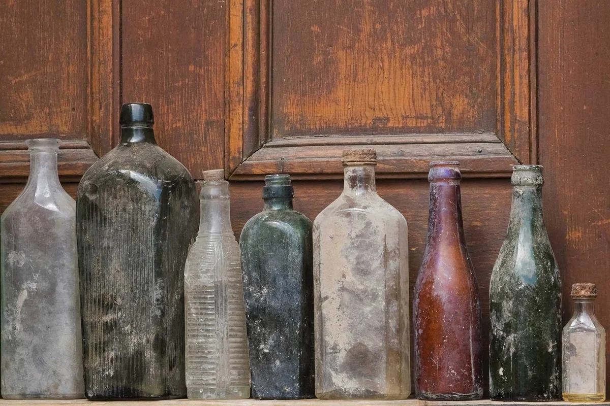 assorted dusty antique bottles