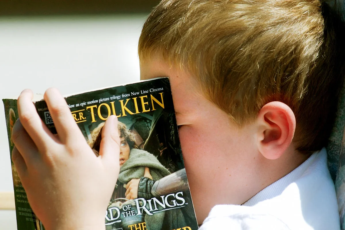 Logan Hohman reads his Lord of the Rings book in a rocking chair Tuesday during the Read-A-Thon | Getty Editorial Use