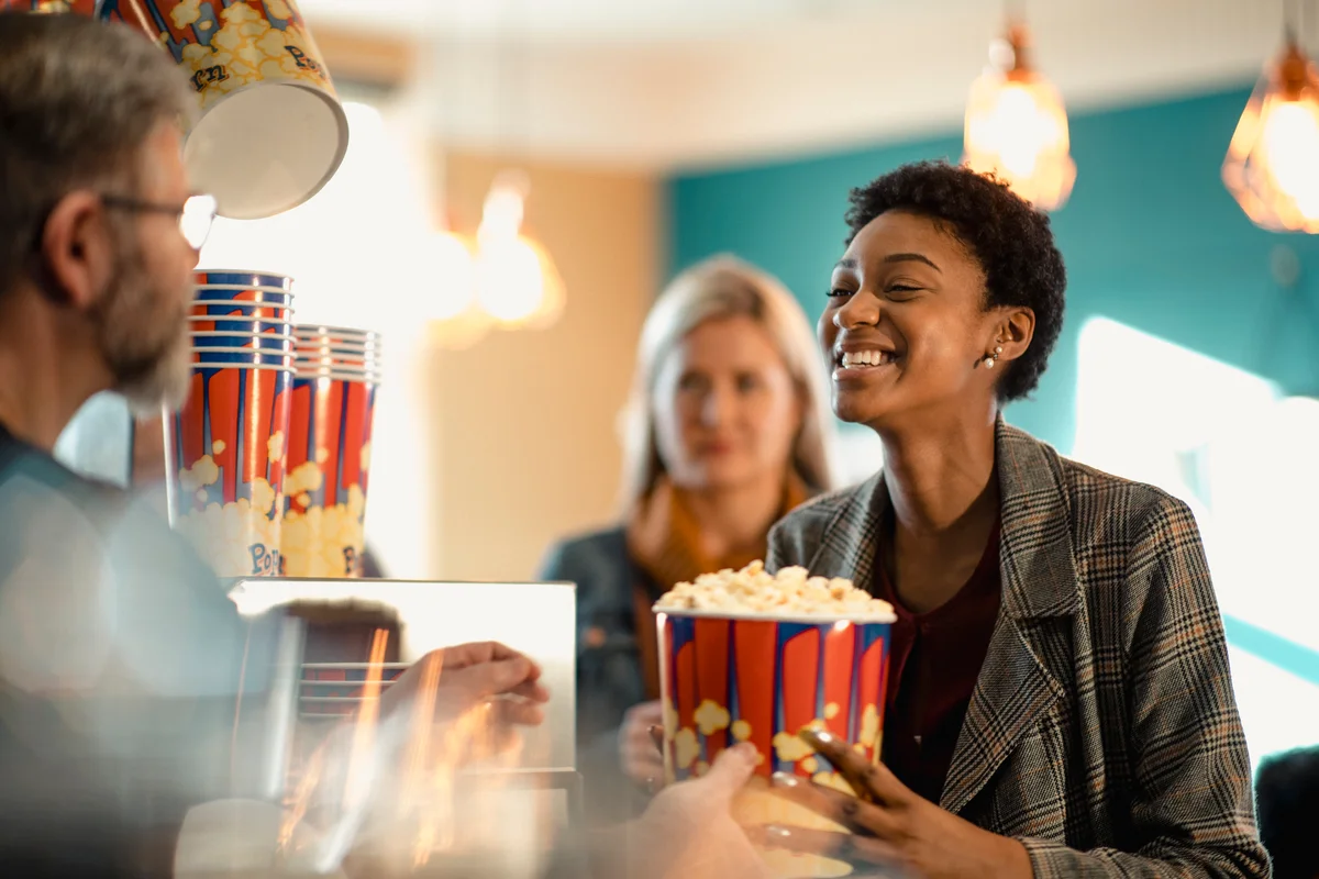 solo woman having fun getting popcorn at movie theater