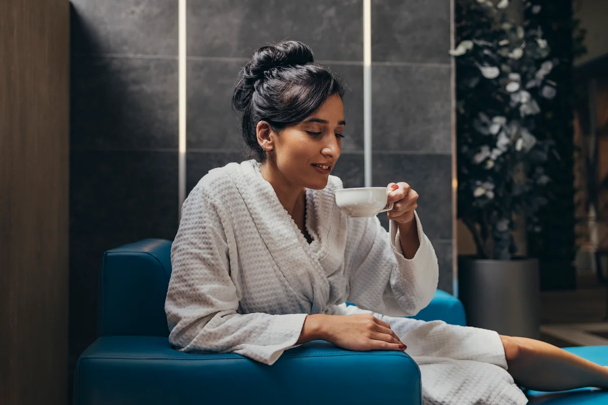 woman at spa drinking herbal tea