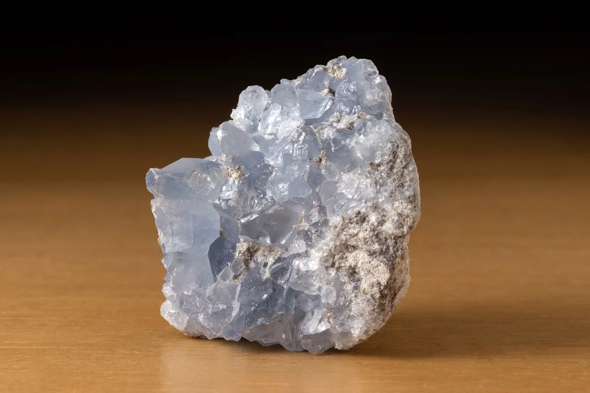 Rock Of Blue Celestine Mineral From Madagascar Iover A Wooden Table