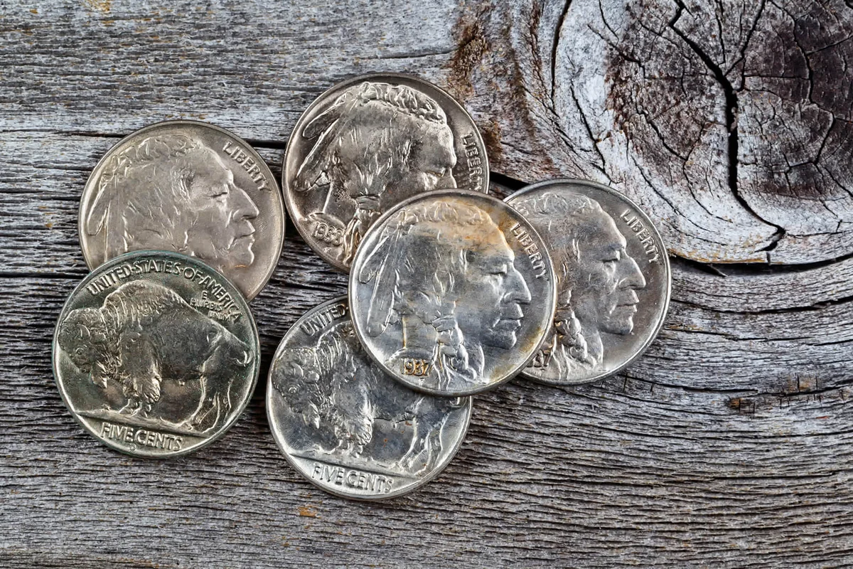 Rare buffalo head nickel coins on rustic wood