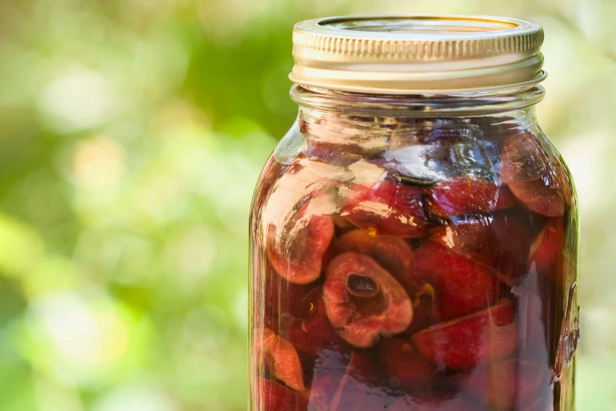 cherry infused vodka in a jar