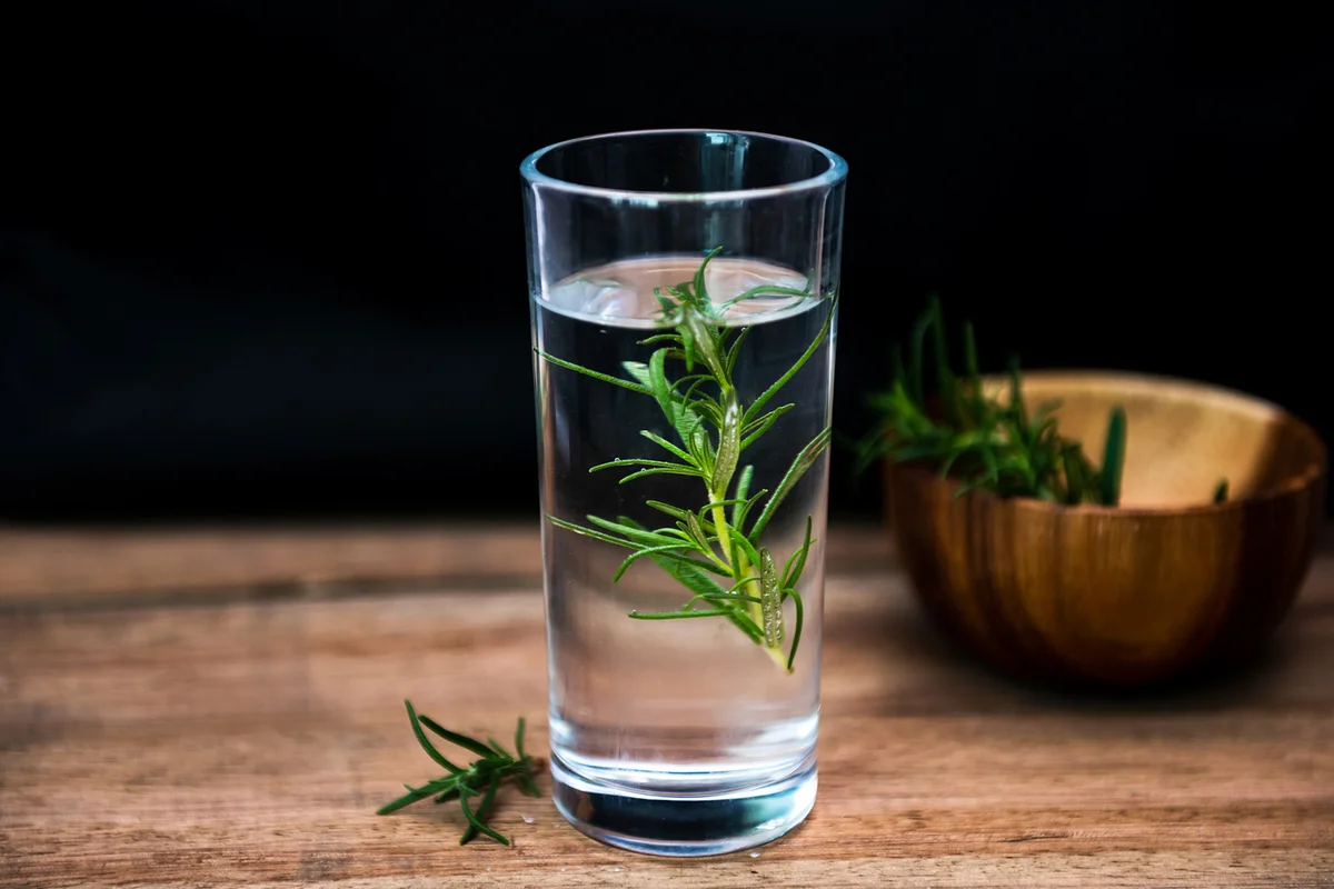 Rosemary-Infused Botanical Gin on rustic wooden background