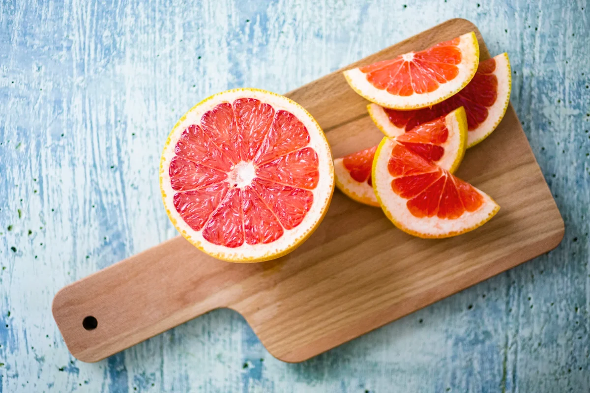 Fresh grapefruit on chopping board
