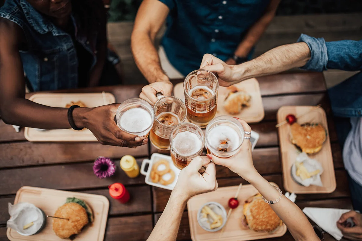 Friends making a toast with different types of beer