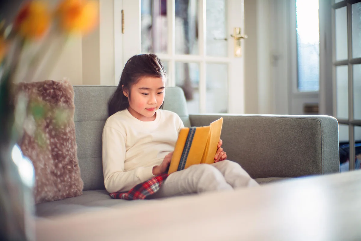 Lovely cheerful girl reading