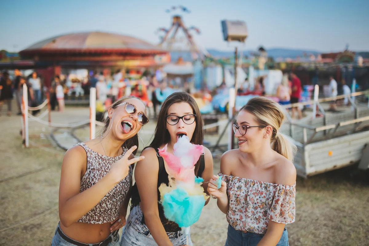 Girls eating cotton candy at the county fair
