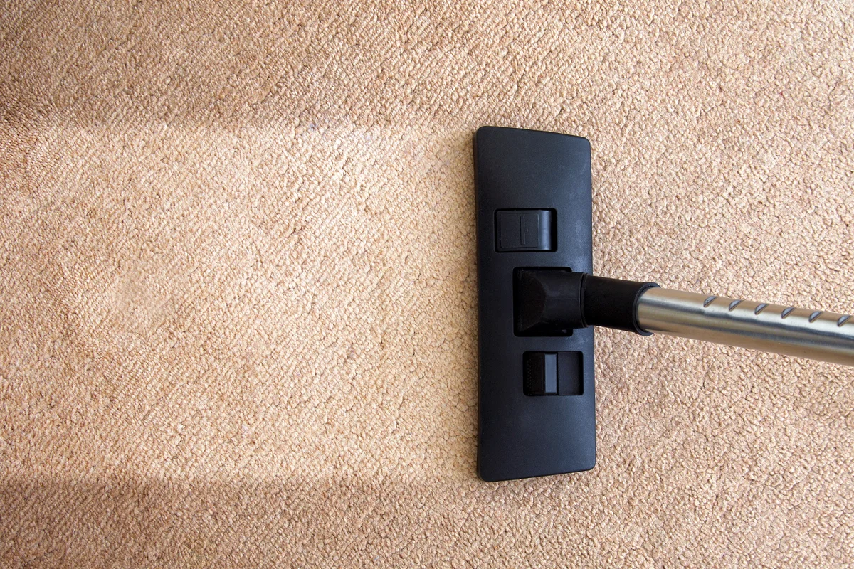 High Angle View Of Vacuum Cleaner On Rug