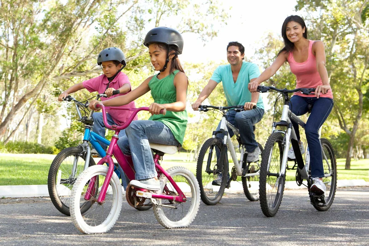 family riding bikes together on Father's Day