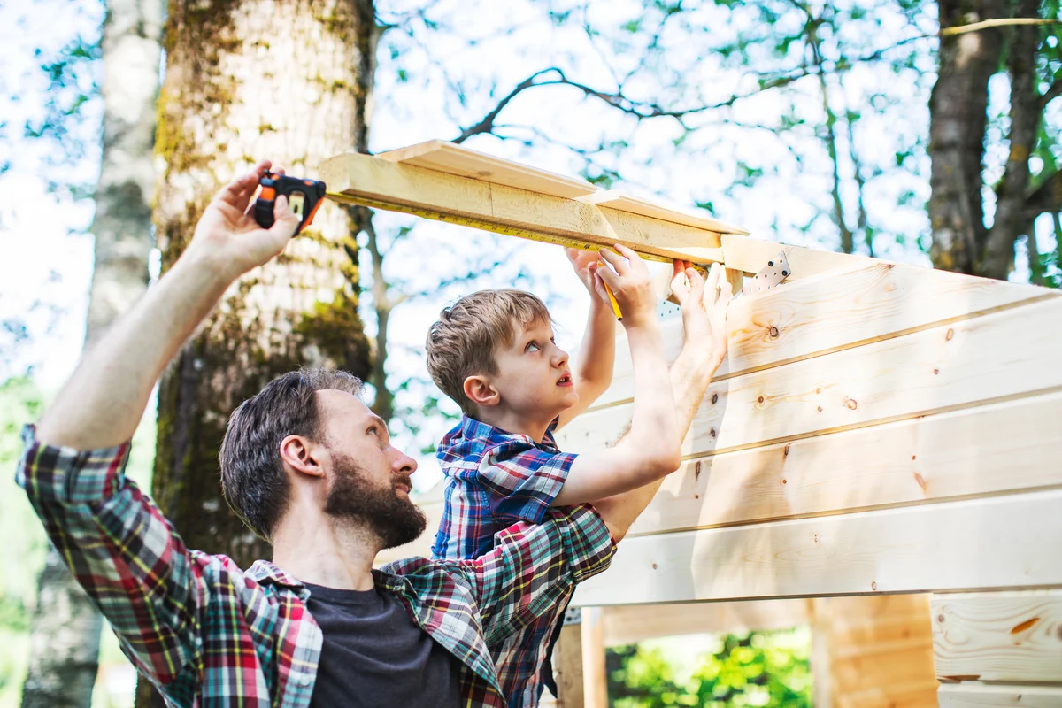 father and son building a fort
