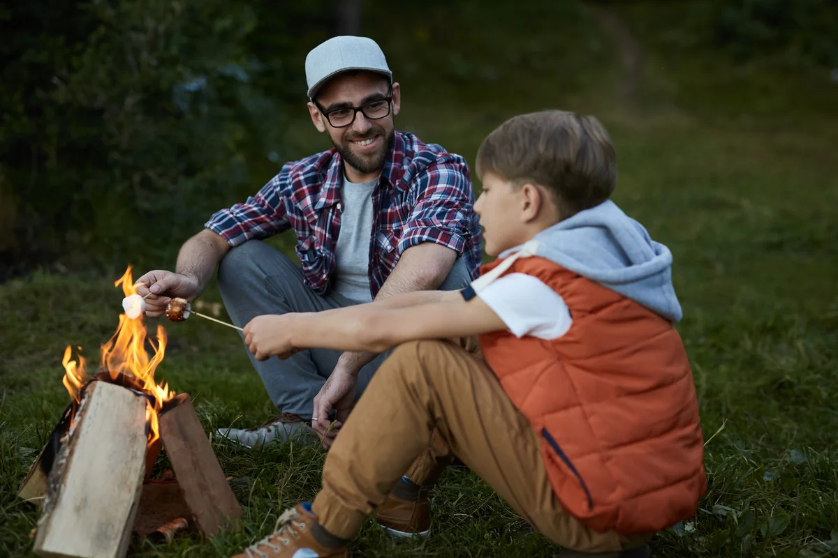 father and son at campfire