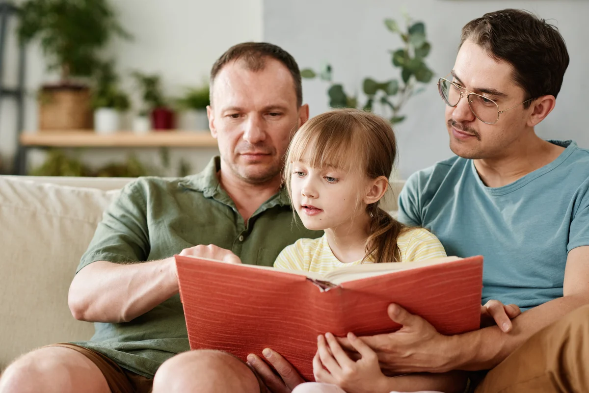 family reading book together for fathers day