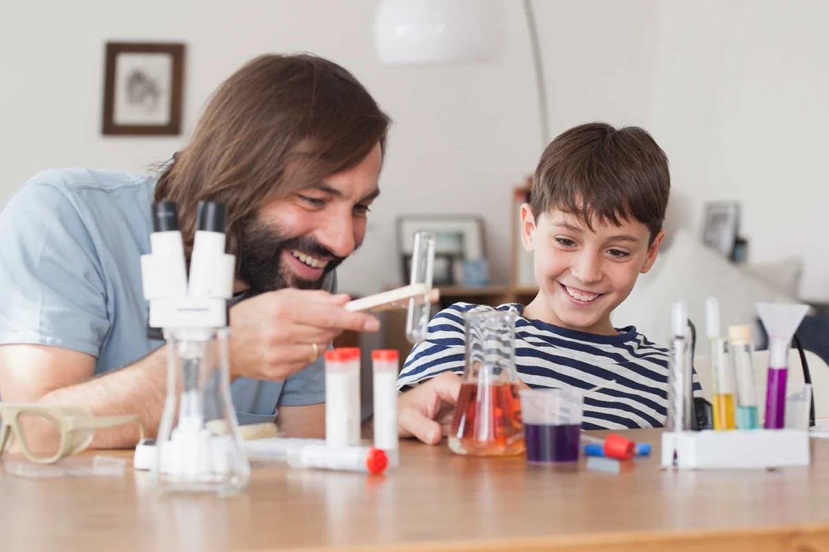 father and son doing science experiment at home