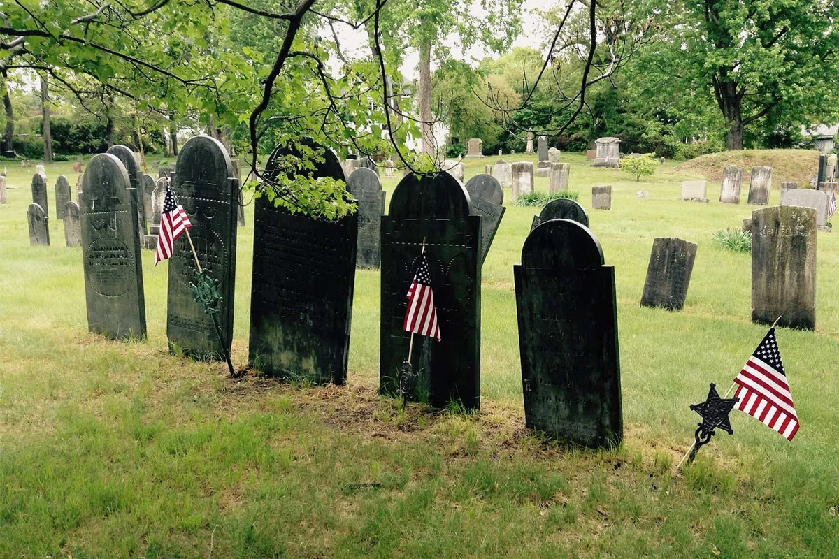 flags in front of gravestones