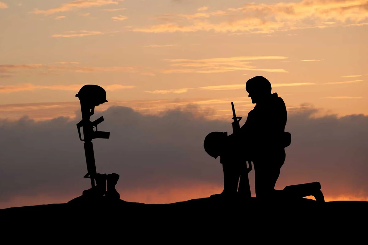 soldier kneeling sunset