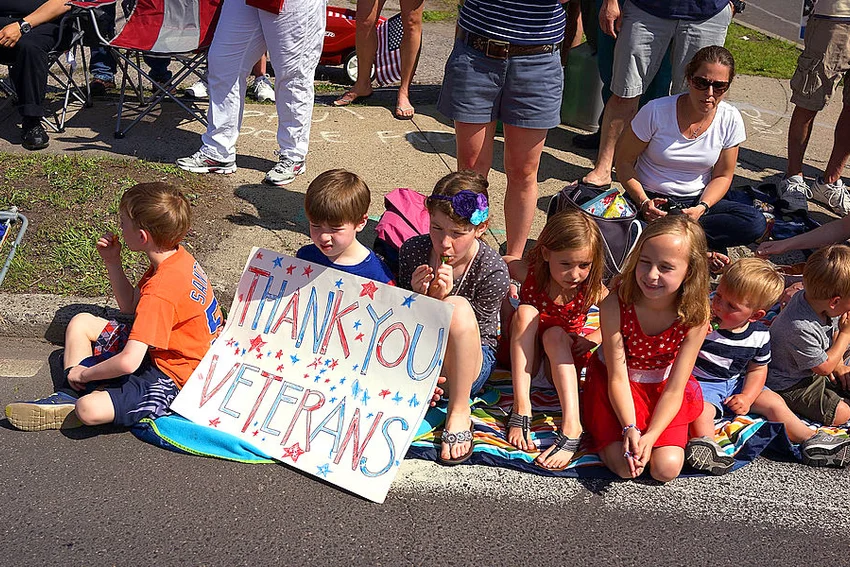 Children watch as people march in the annual Memorial Day Parade on May