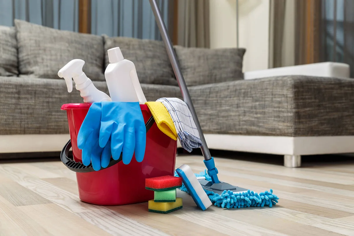 Bucket with sponges, chemicals bottles and mopping stick