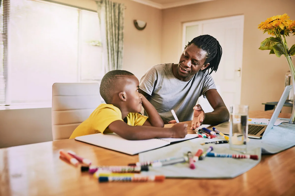 Father helping his son with his homework at home