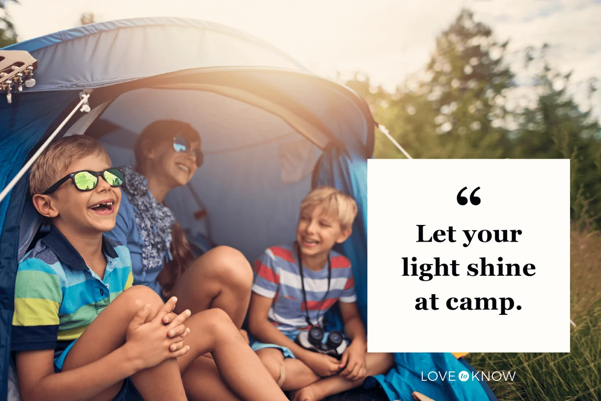 Kids having fun camping in tent on the forest meadow