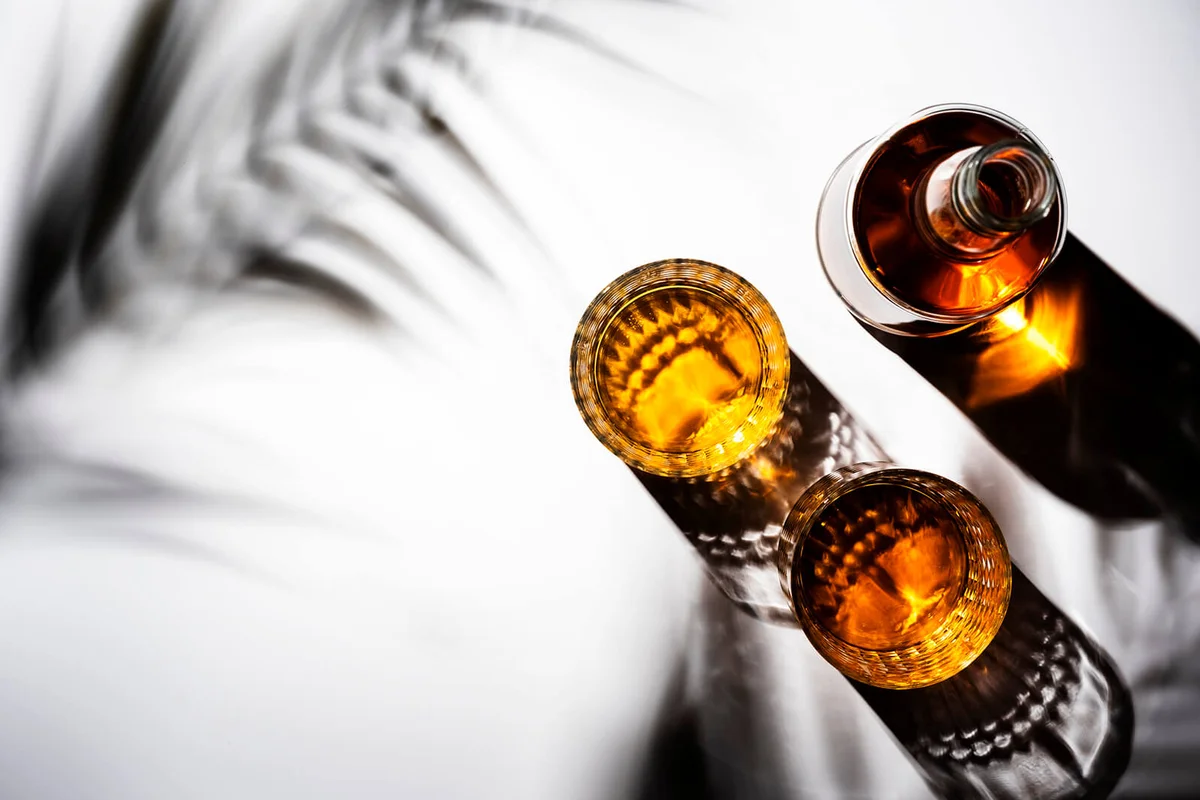 Rum in glasses and bottle