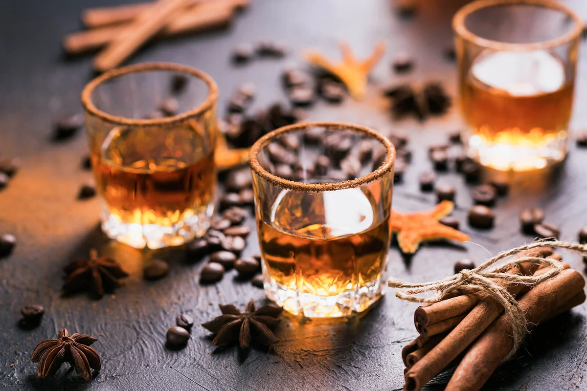 liquor, spices, anise stars, coffee beans, cinnamon sticks
