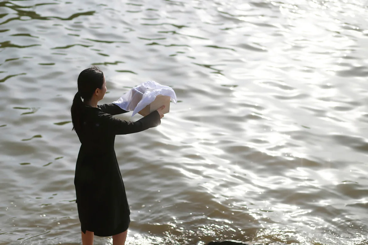 Woman grieving with funeral urn