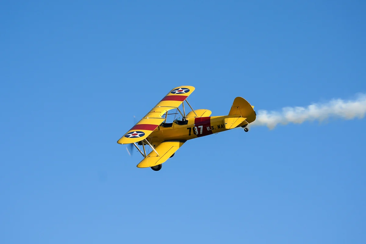 yellow aeroplane on sky