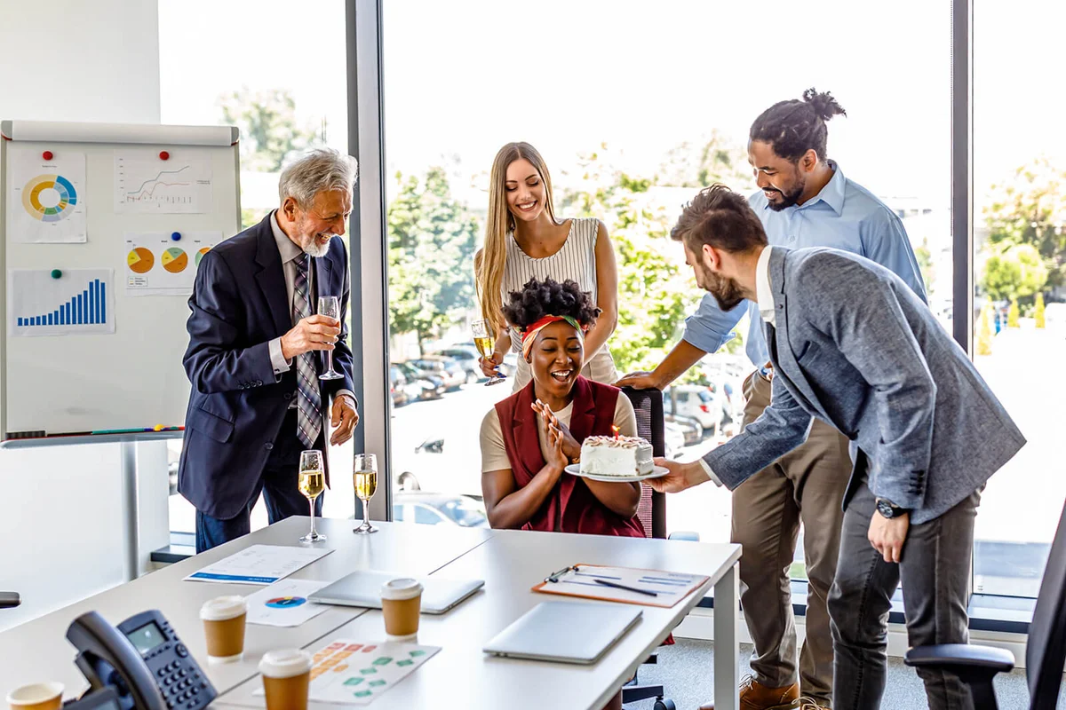Woman is Celebrating her Birthday at the Office with her Coworkers
