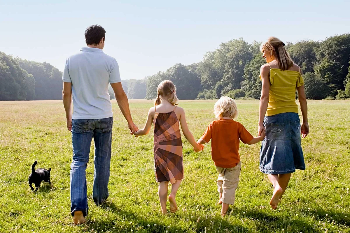 family walking together outside holding hands