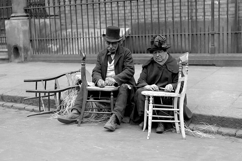 Chair menders at work by the side of the pavement