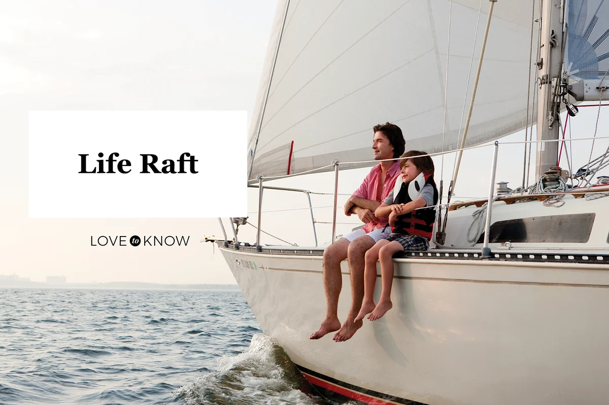 Father and son sitting on yacht