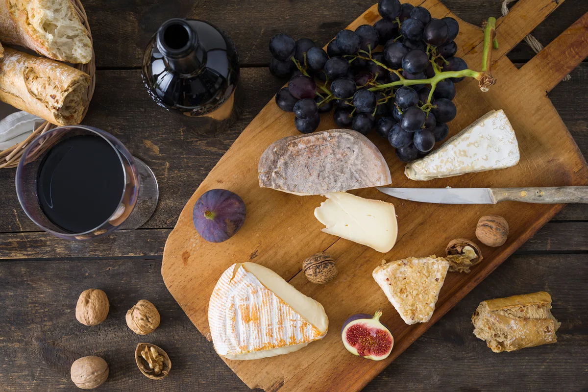 Red wine with cheese platter and grapes