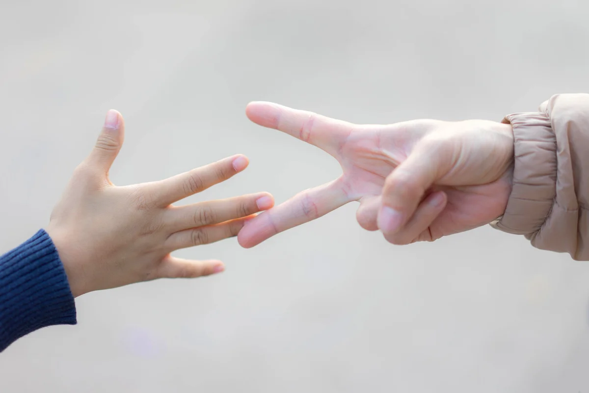 Children playing rock-paper-scissors game