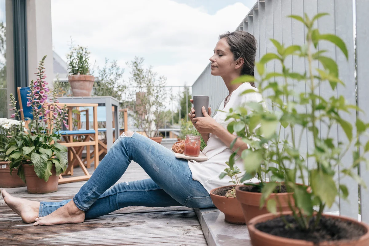 Woman eating on balcony
