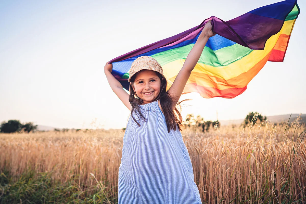 girl holding the LGBTQ flag