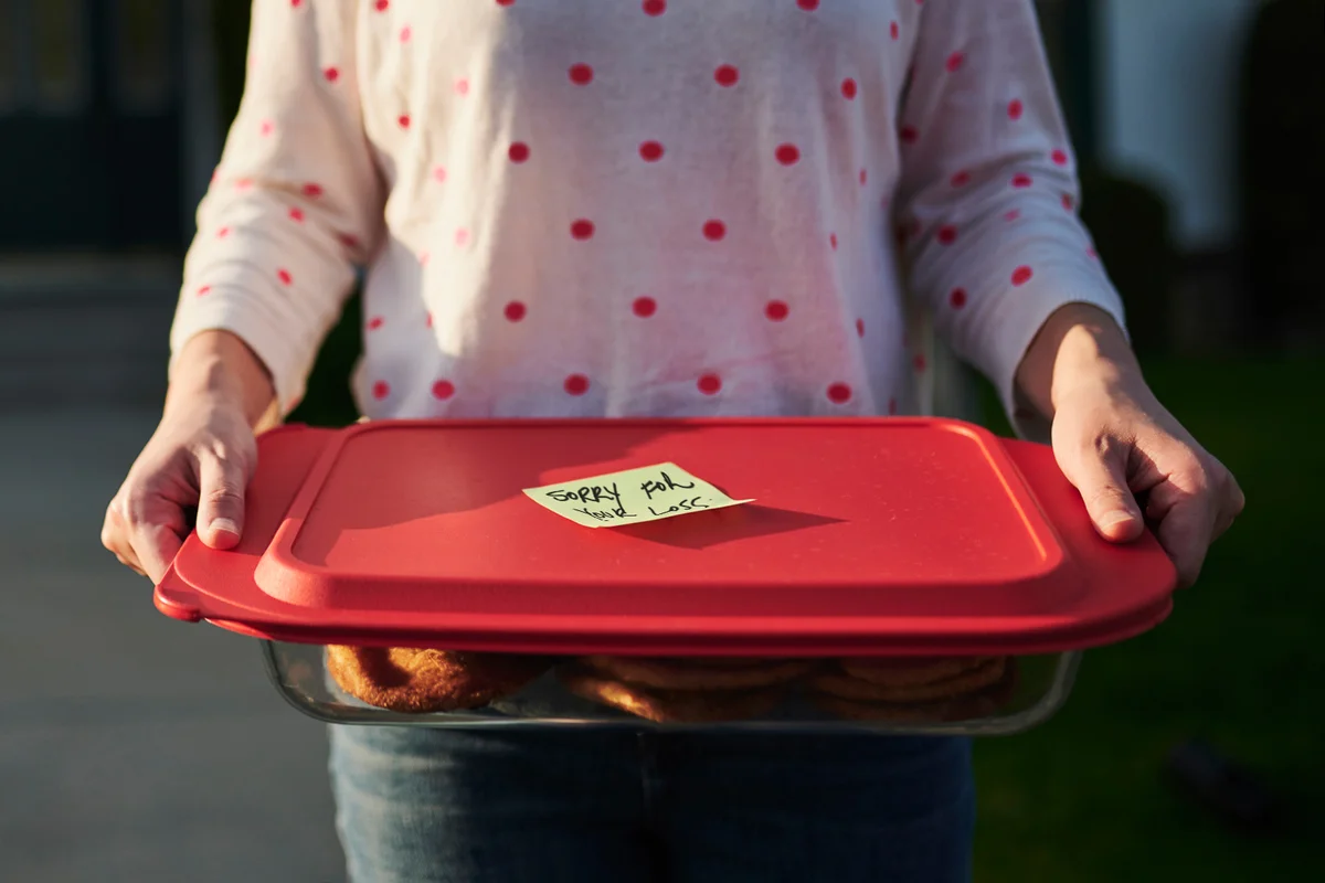 Woman delivering care package to neighbor
