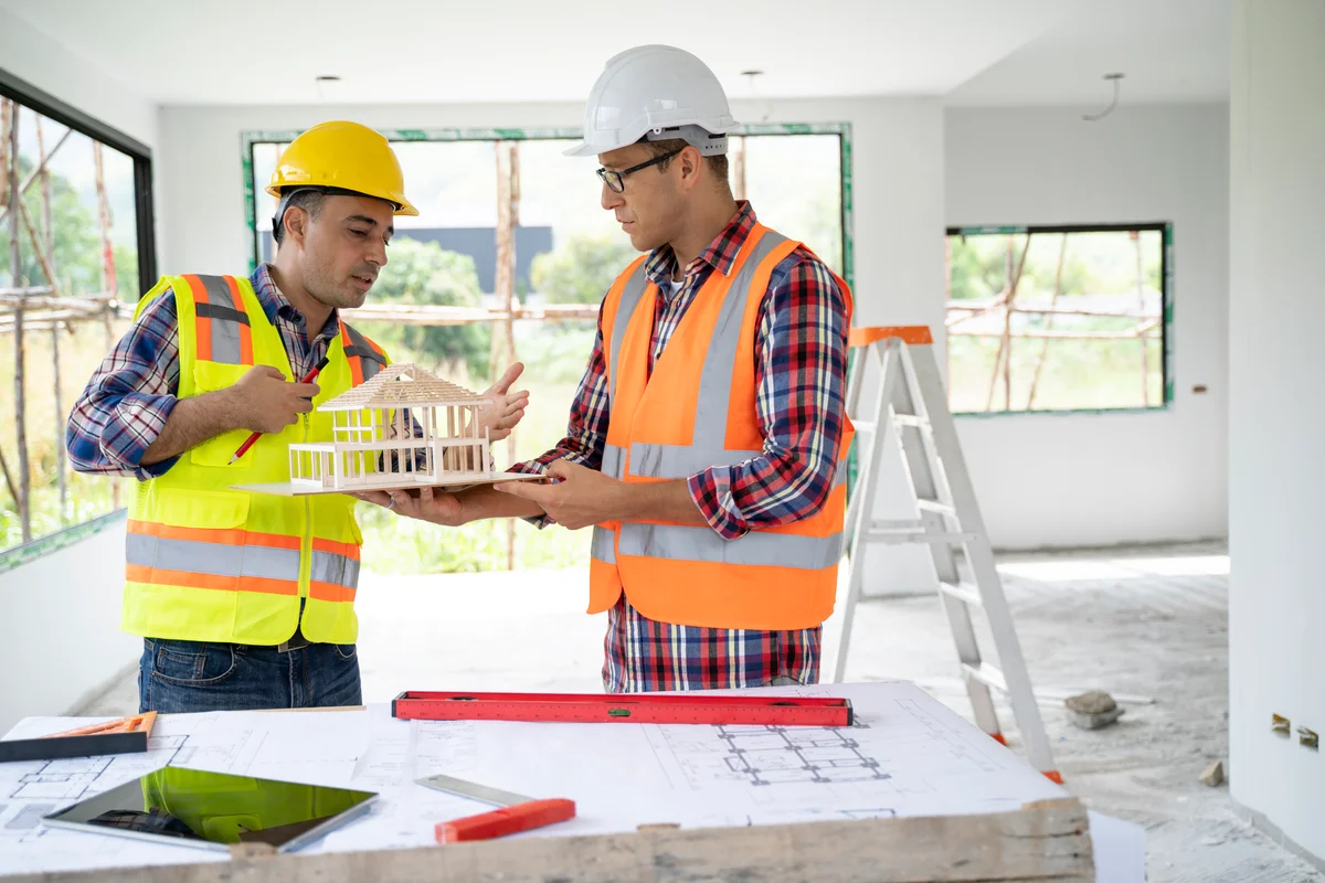 construction engineers studying a house mockup