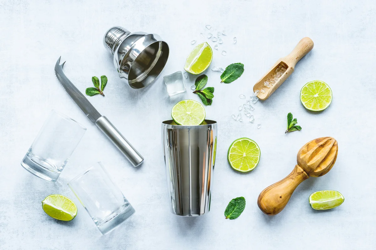 Bartender equipment and cocktail ingredients - shaker, lime and ice