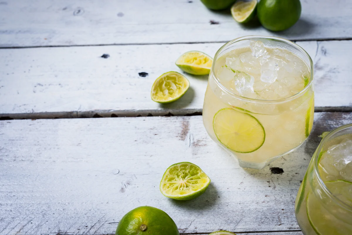Caipiroska cocktail with ice and lime slice