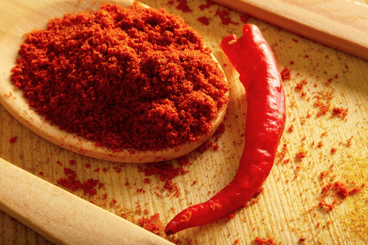 Red powder pepper in wooden spoon