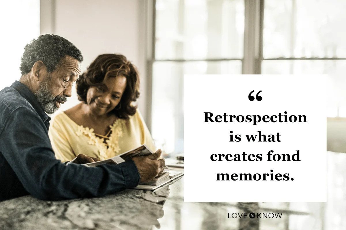 Senior couple looking through photo album at home