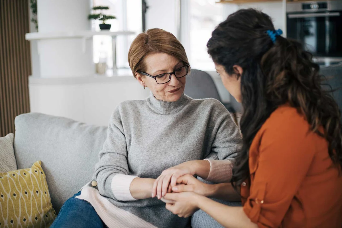 adult daughter having serious conversation with mother