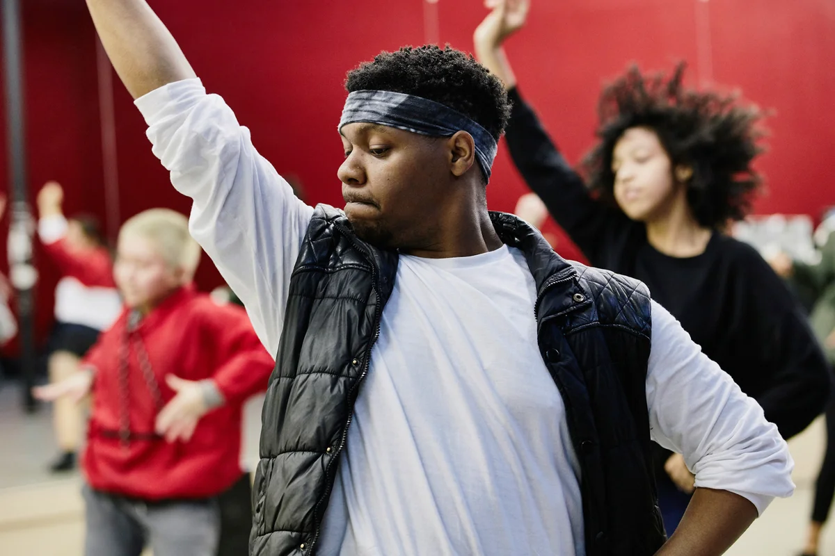 Dance instructor leading hip hop class in dance studio